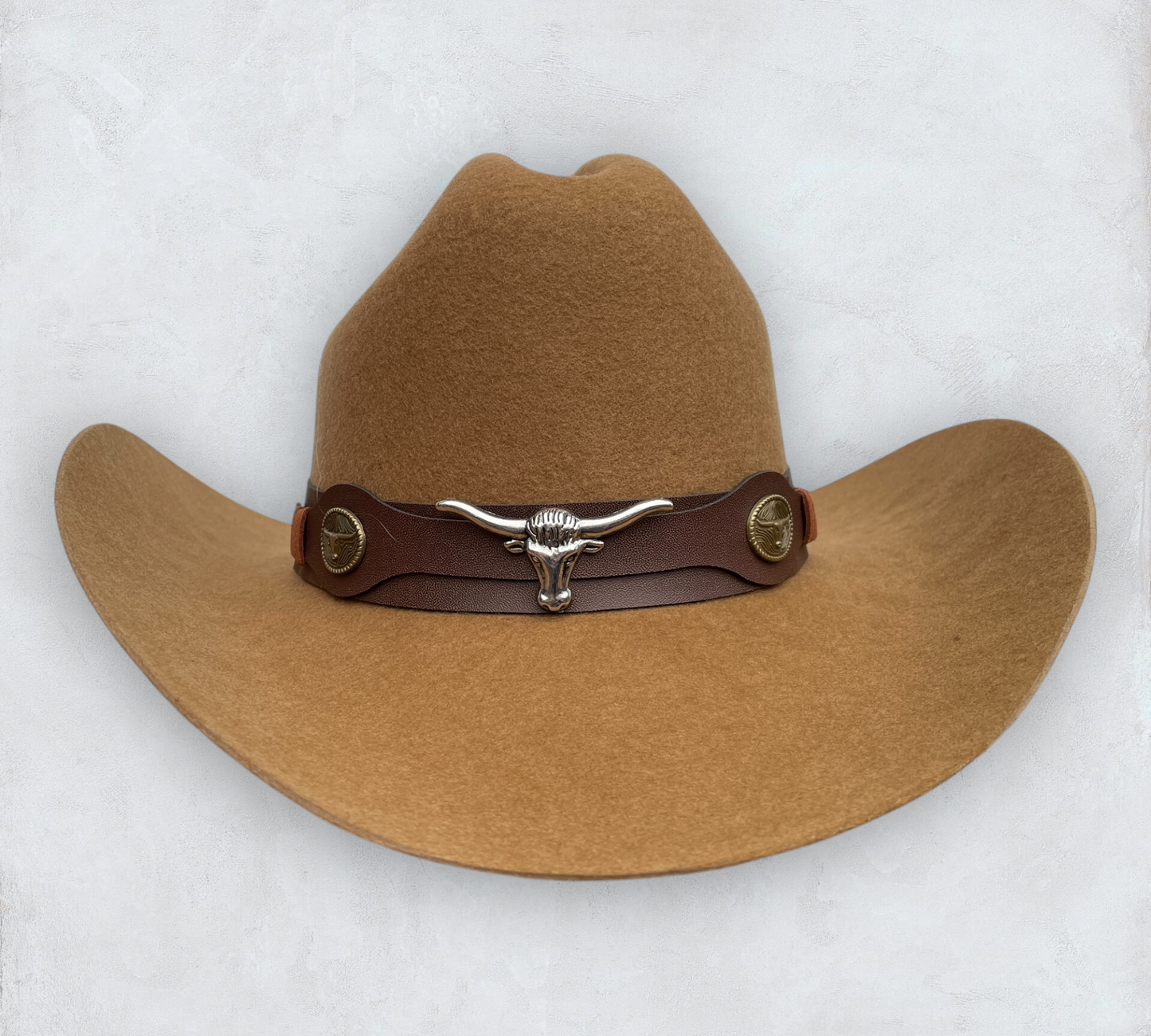 Brown cowboy hat made of high-quality felt with leather band and metal bull head