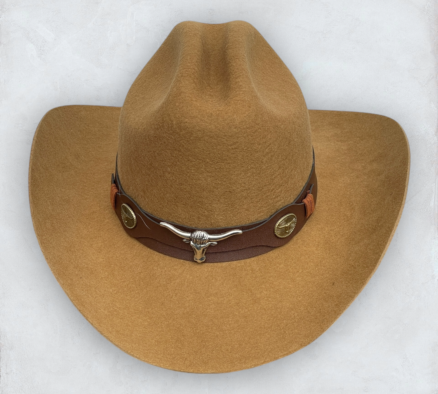 Brown cowboy hat made of high-quality felt with leather band and metal bull head