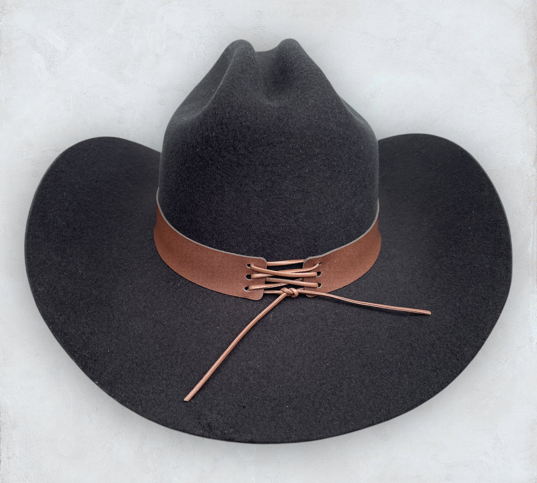 Black cowboy hat made of high-quality felt with leather band and metal bull head