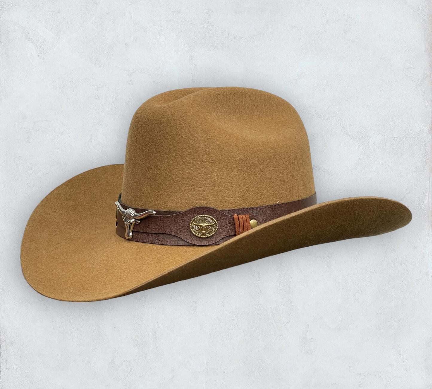 Brown cowboy hat made of high-quality felt with leather band and metal bull head