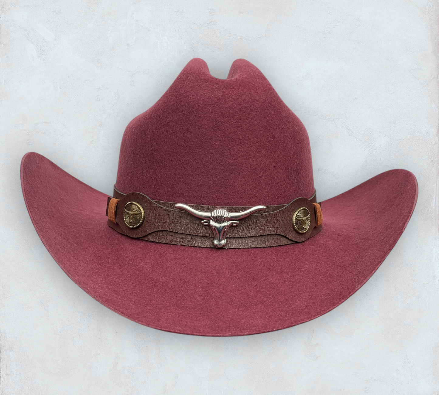 Red cowboy hat made of high-quality felt with leather band and metal bull head