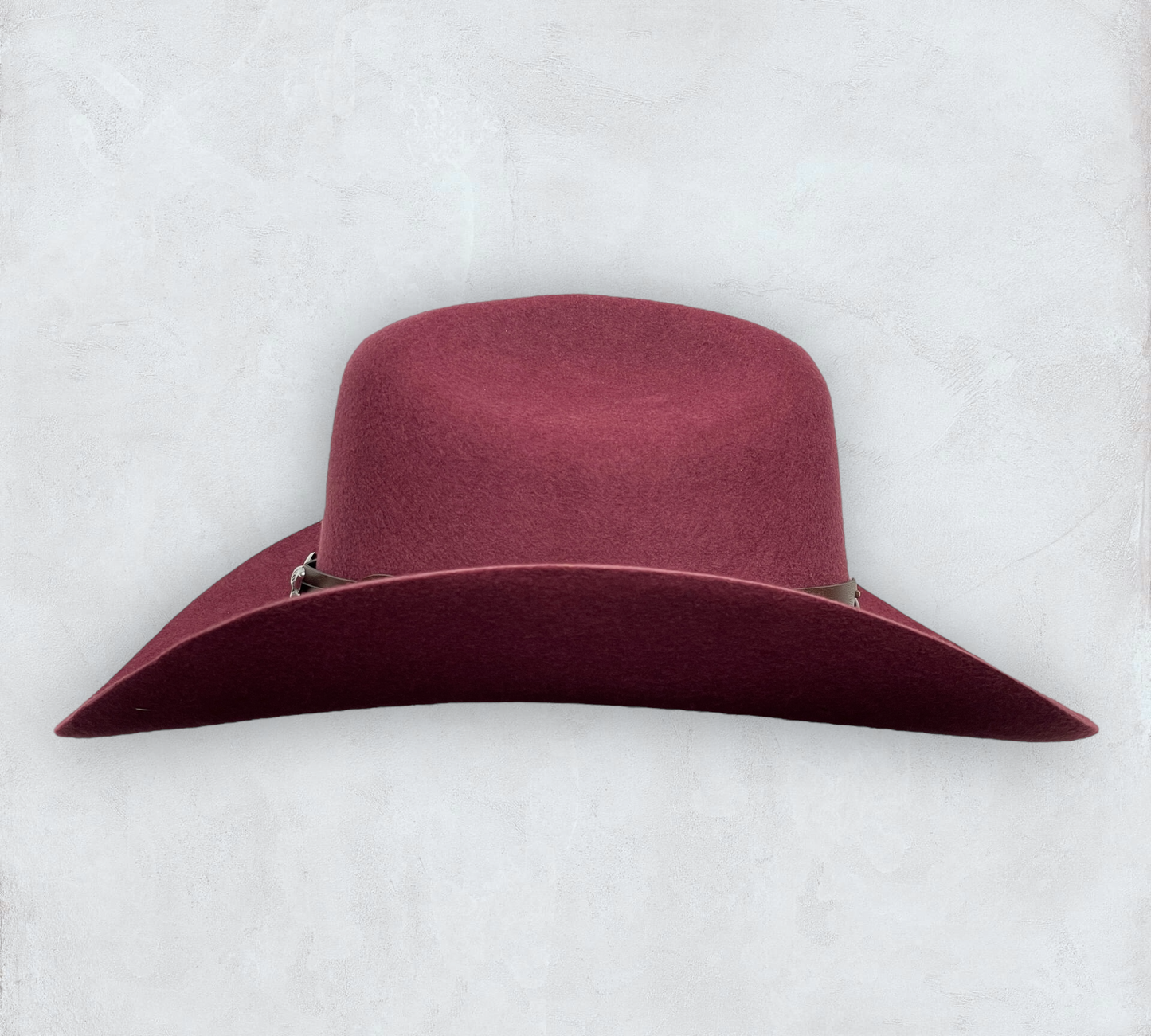 Red cowboy hat made of high-quality felt with leather band and metal bull head