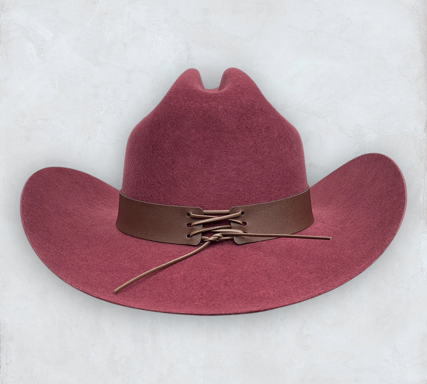 Red cowboy hat made of high-quality felt with leather band and metal bull head