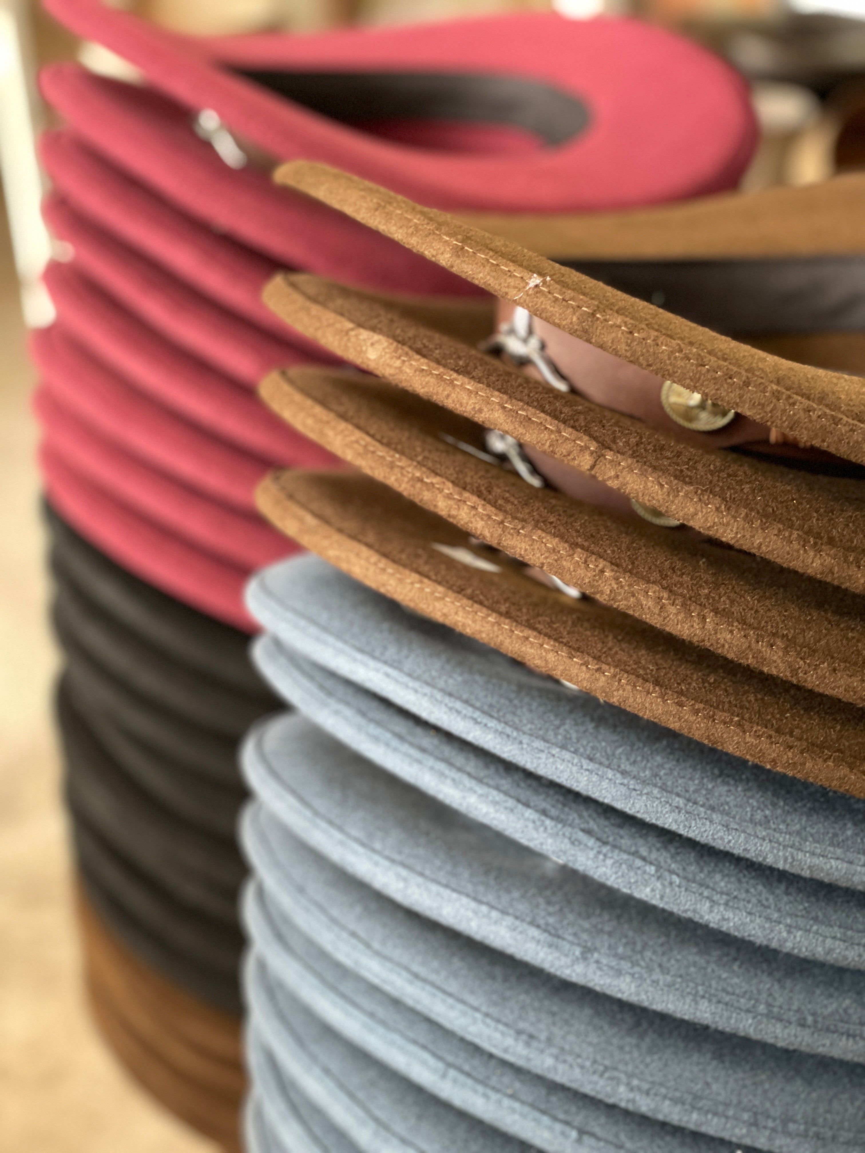 Several differently colored felt hats in a workshop in Ecuador