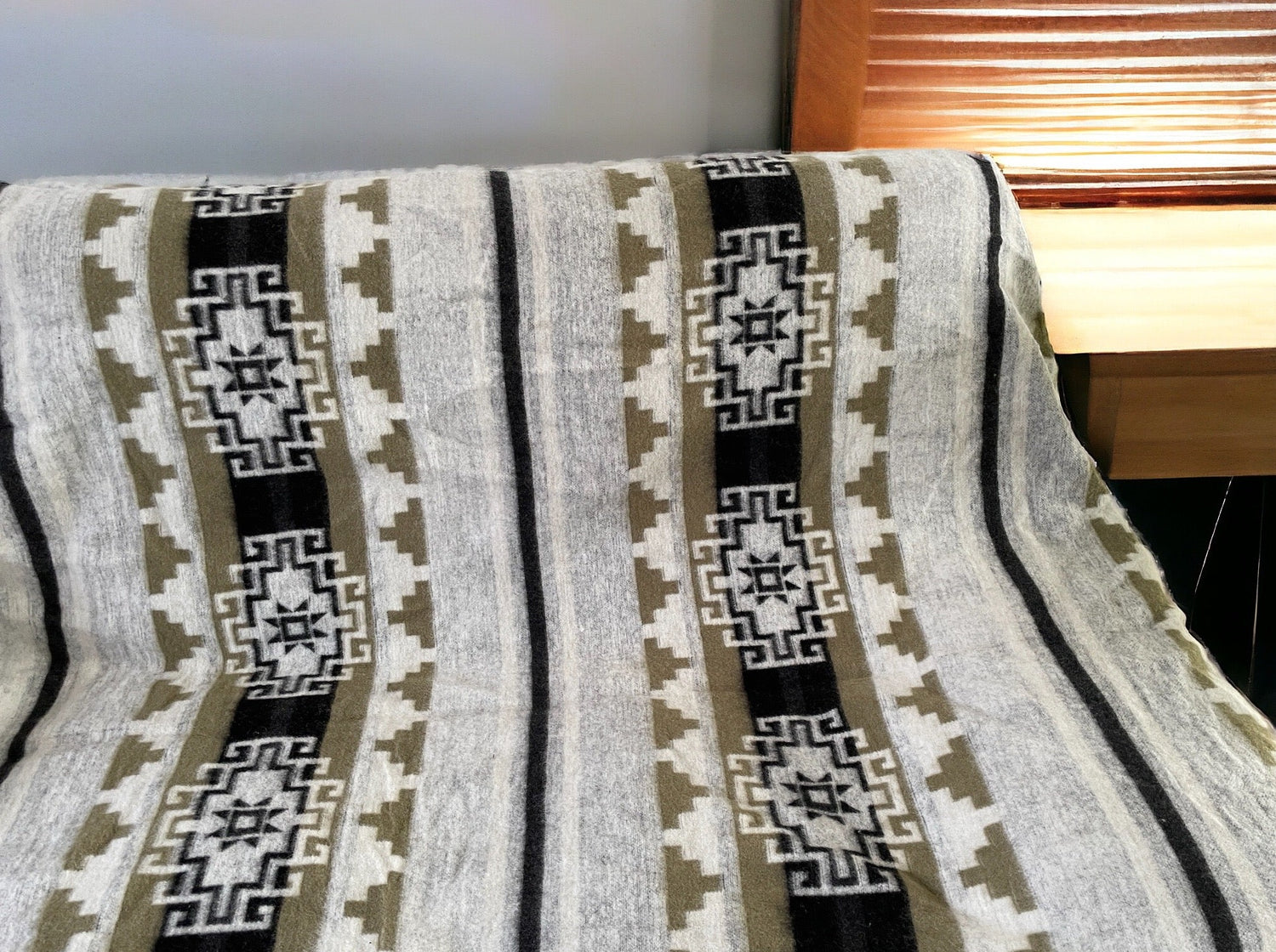 Thick beige blanket with indigenous patterns in white and beige