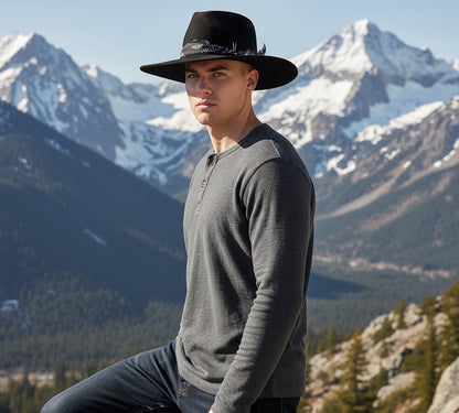 TomHats Havana black wool felt boater hat with bandana detail, worn by a man against a mountain backdrop.
