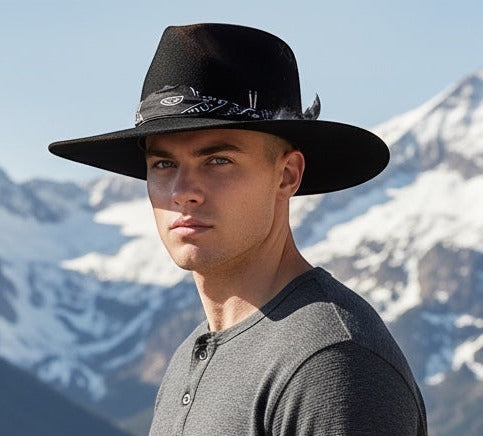 TomHats Havana black wool felt boater hat with bandana detail, worn by a man against a mountain backdrop.
