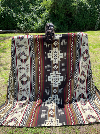 TomHats brown alpaca blanket featuring traditional indigenous geometric patterns, handmade and displayed outdoors.